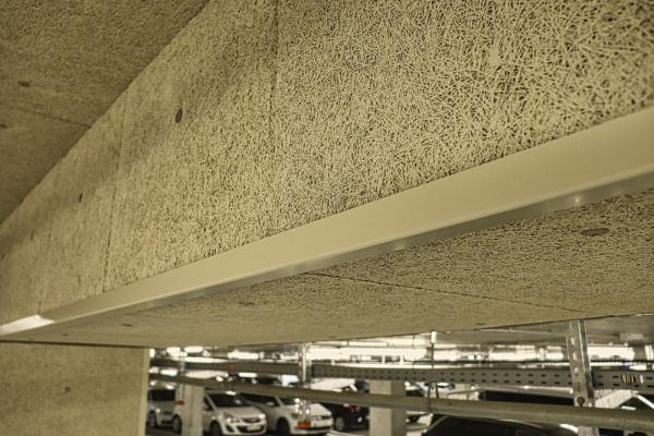 Heraklith wood wool panels on the ceiling of an underground garage.