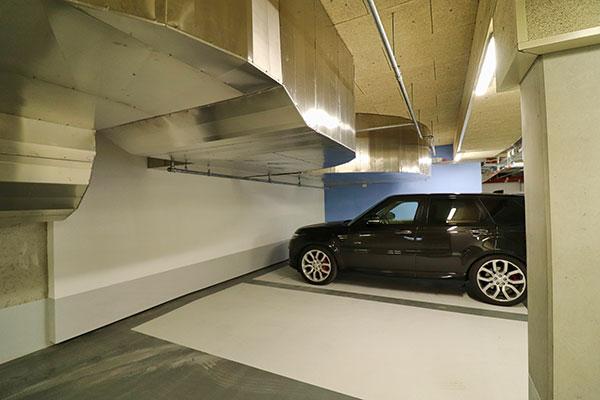 A black car in the garage with Heraklith wood wool panels on the ceiling.